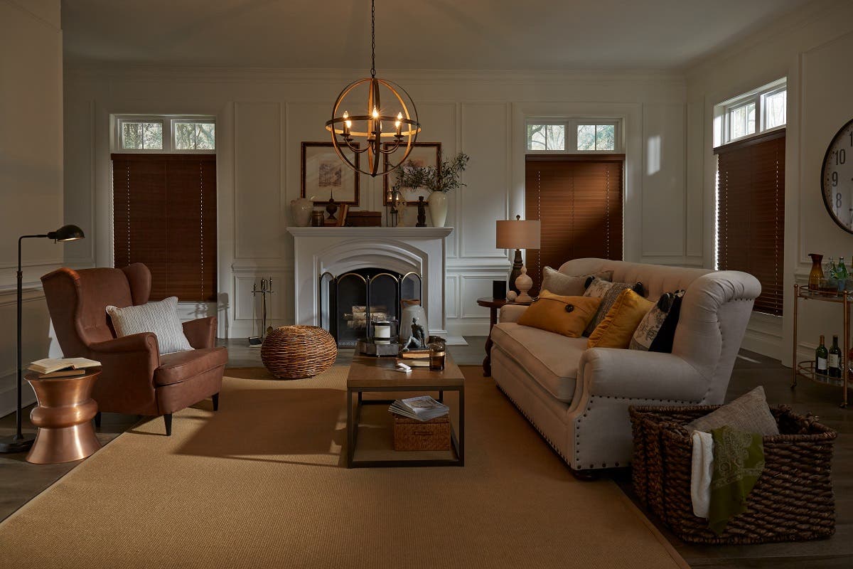 Living room with warm color accents and fully closed wooden blinds